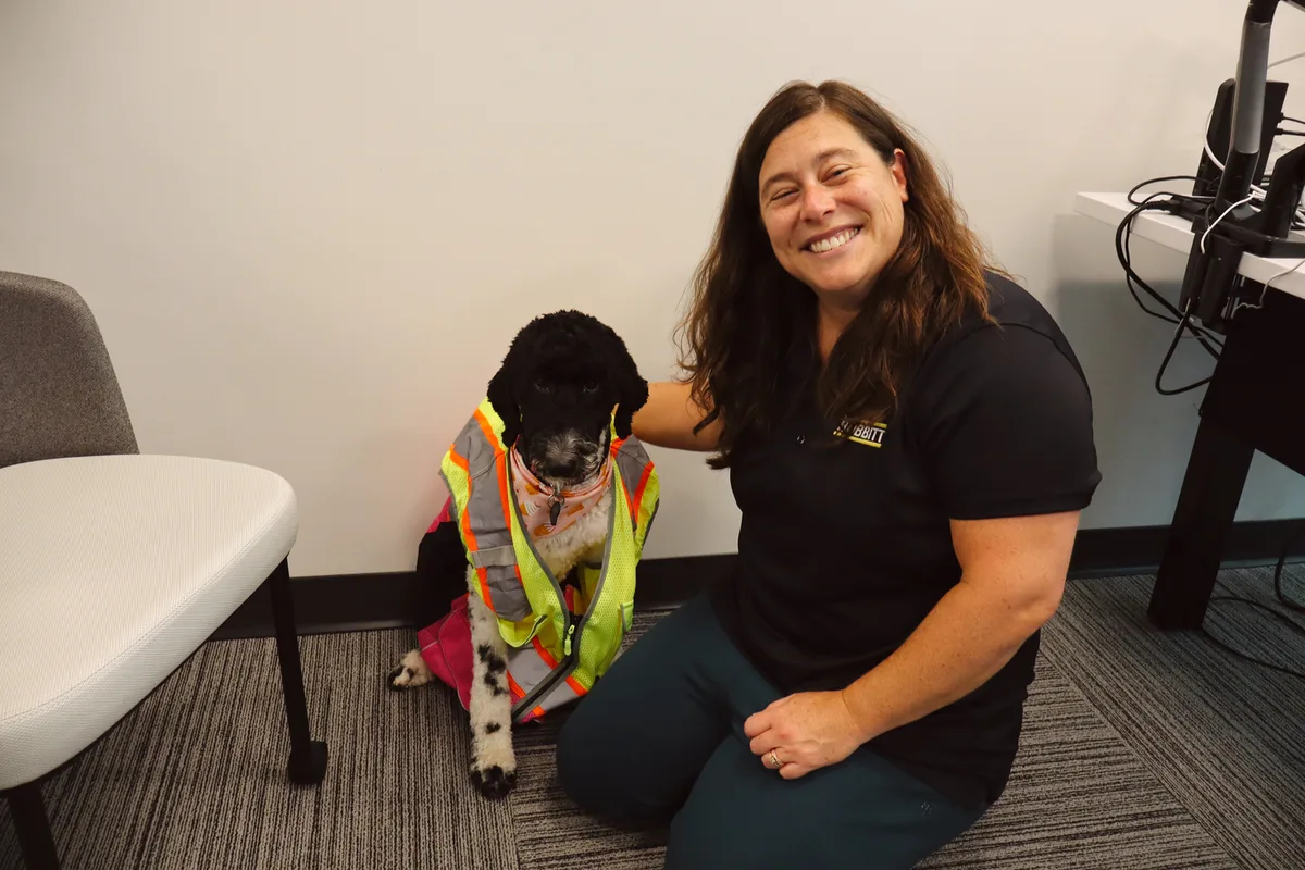 Bobbitt team member with an office dog at work